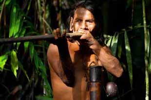 Typical huaorani hunter portrait, waorani reserve, Yasuni national park, Ecuador. Shoot in the jungle in ambient light.