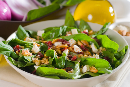 plate of fresh colorfull spinach salad close up